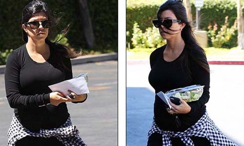 Pregnant Kourtney Kardashian in tight black mini dress